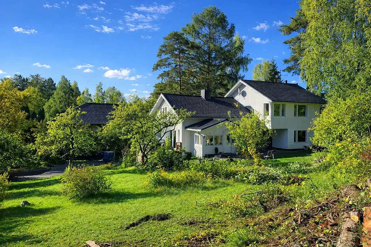 Villa Mehiläinen in Vantaa — white house and green garden in summer